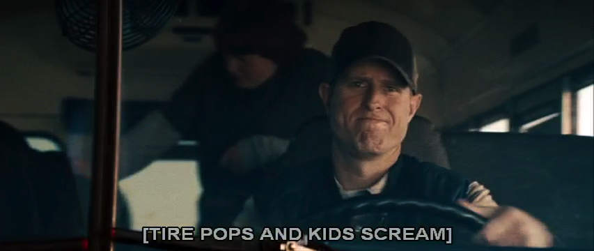 A frame from Man of Steel showing a school bus driver gripping the wheel, with a caption describing a tire pop and kids screaming.