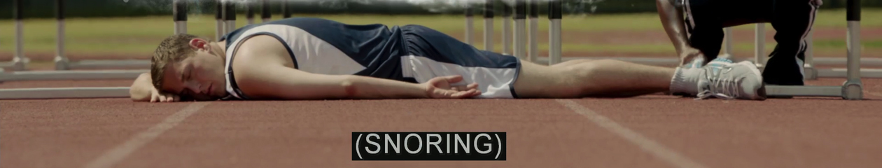 A frame from 21 Jump Street (2012) showing Jonah Hill lying face down on a hurdling track. He's wearing a track shorts and tank top. His eyes are closed. The closed caption is: (SNORING).