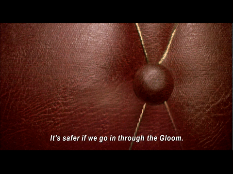 An animated gif from Night Watch featuring a subtitle that recedes and breaks apart as the characters go into the Gloom. Subtitle: "it's safer if we go in through the Gloom."